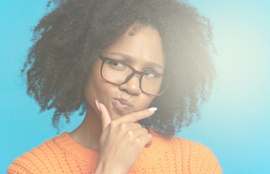 An inquisitive woman holding her chin.